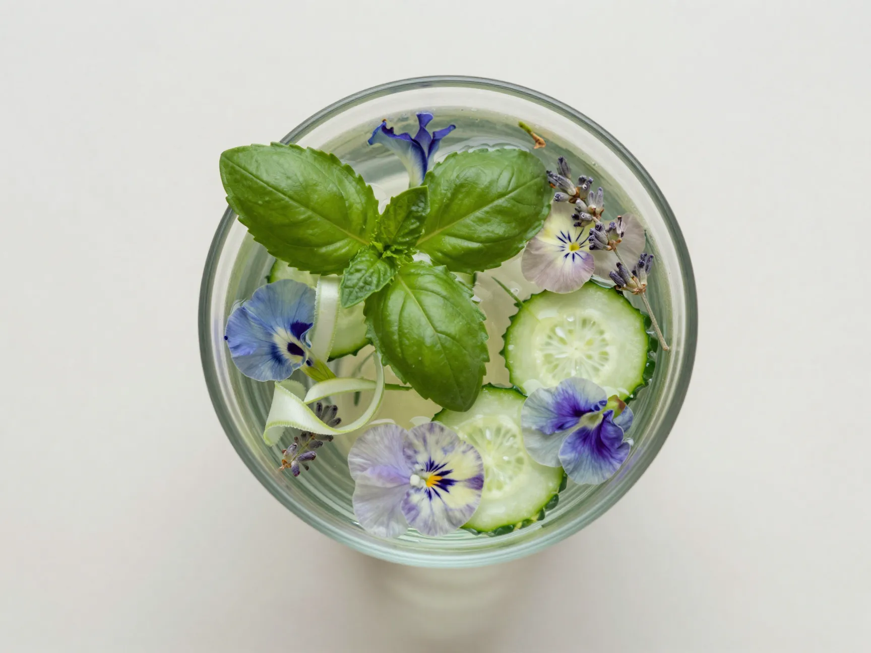 Topdown flatlay botanical garden mocktail cucumber basil herb garnish