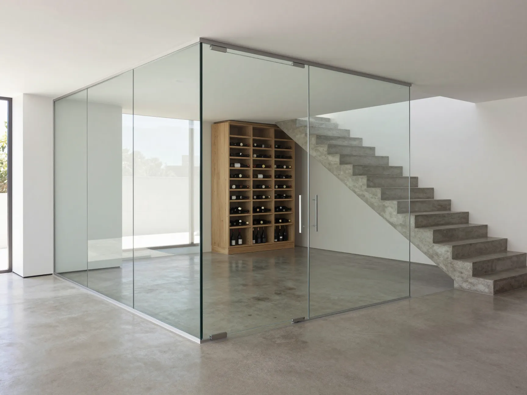 Frameless glass cellar door in an ultra modern home with polished concrete