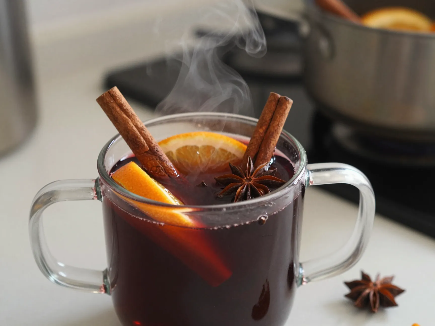 Warm nonalcoholic mulled wine in heatproof mug with citrus spices