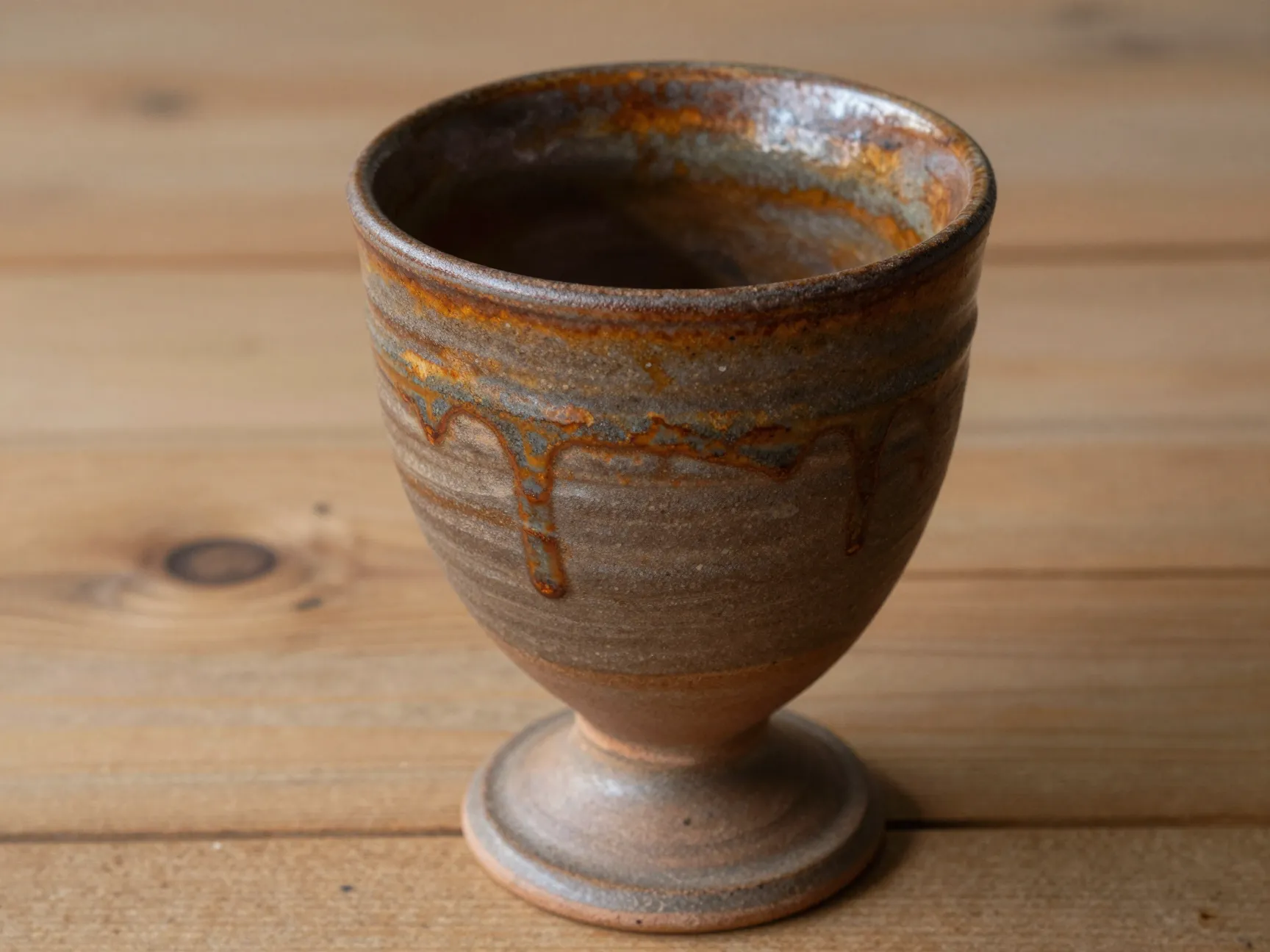 Rustic stoneware goblet dripped glaze wooden farmhouse table