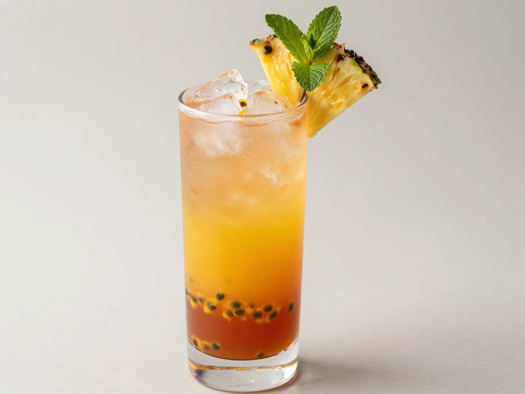 Tropical sunset layered pour in tall glass with mango passion fruit