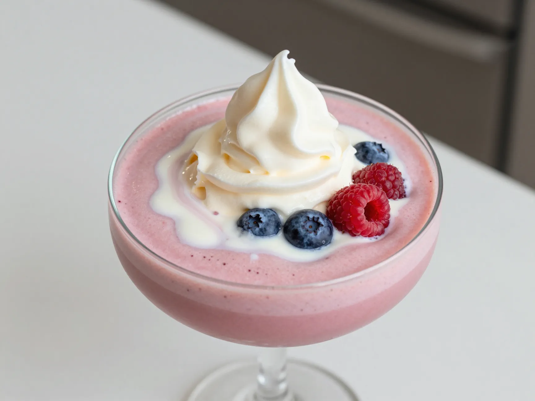 Smoothie with high protein vanilla foam and berry garnish