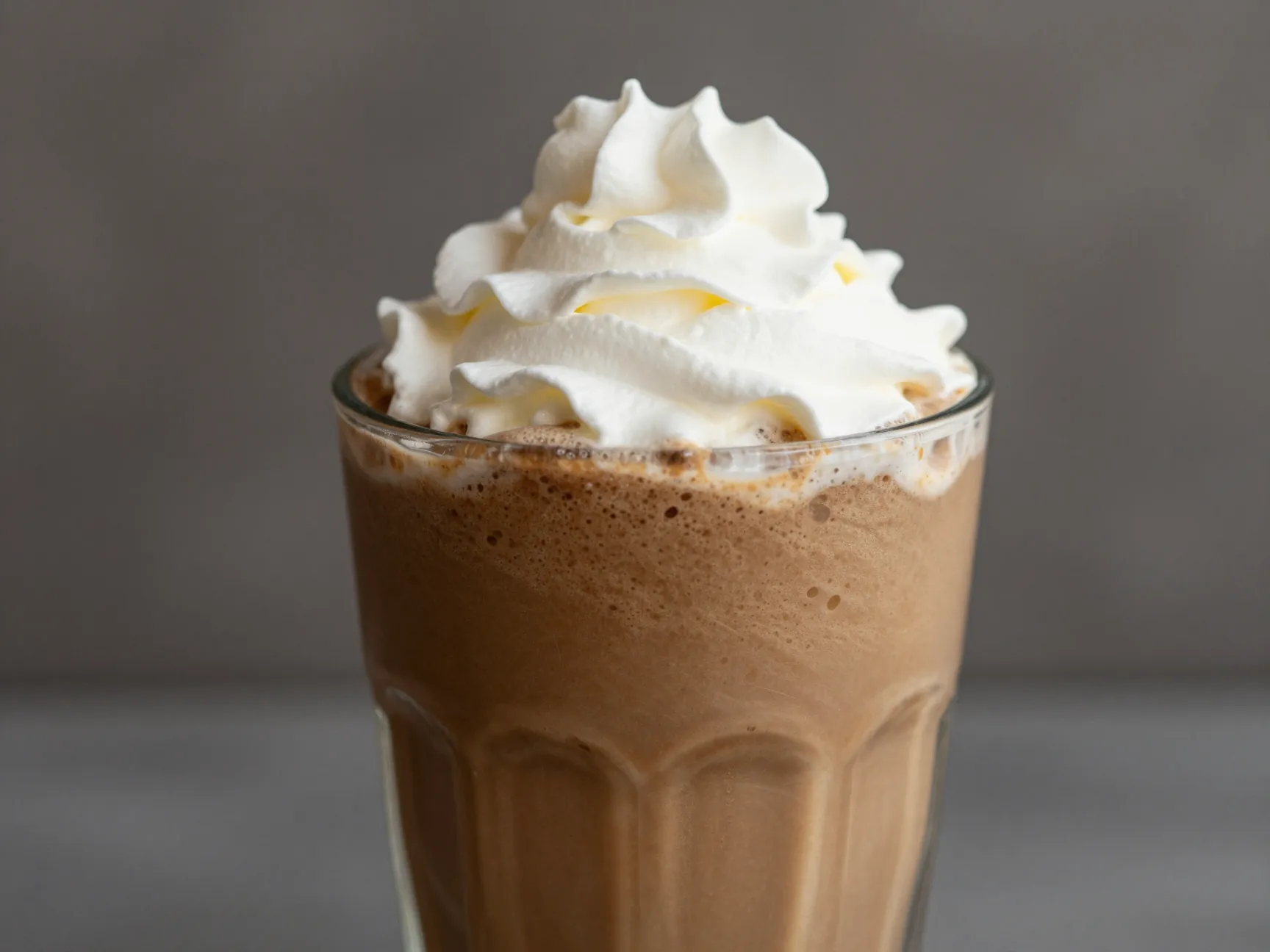 Creamy coffee frappe slushie with vanilla in glass