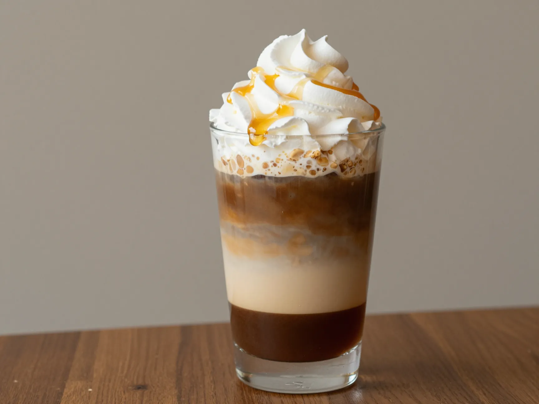 Layered jeju honey peanut latte in clear glass with cream
