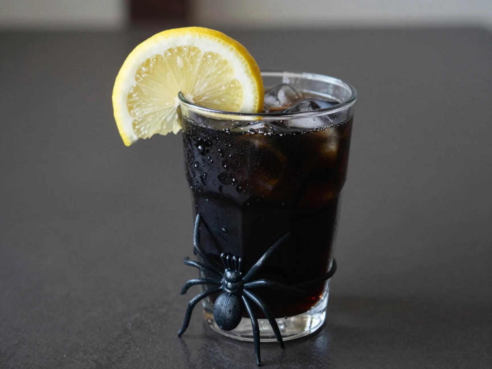 Jet black lemonade with plastic spider ring garnish