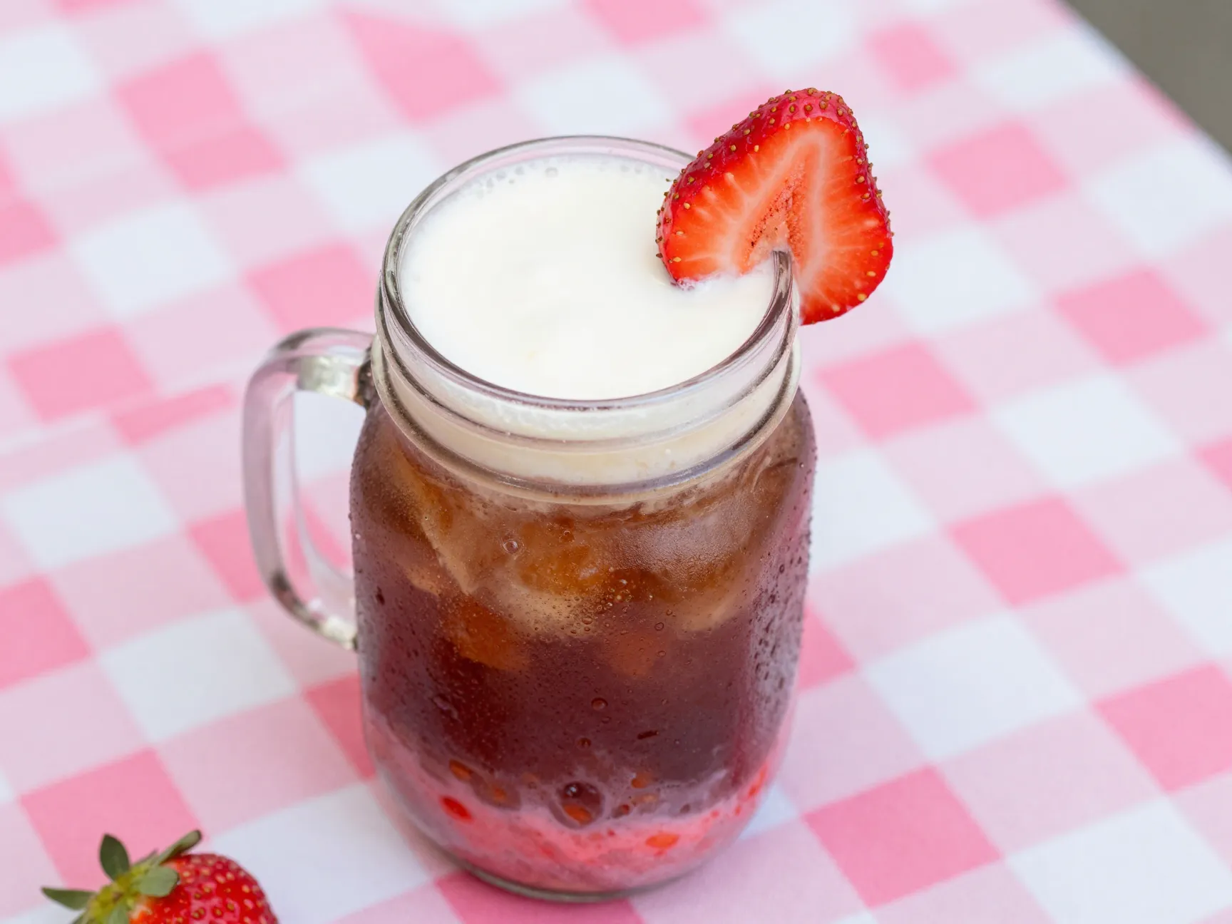 Strawberry cream root beer dirty soda with fresh berry