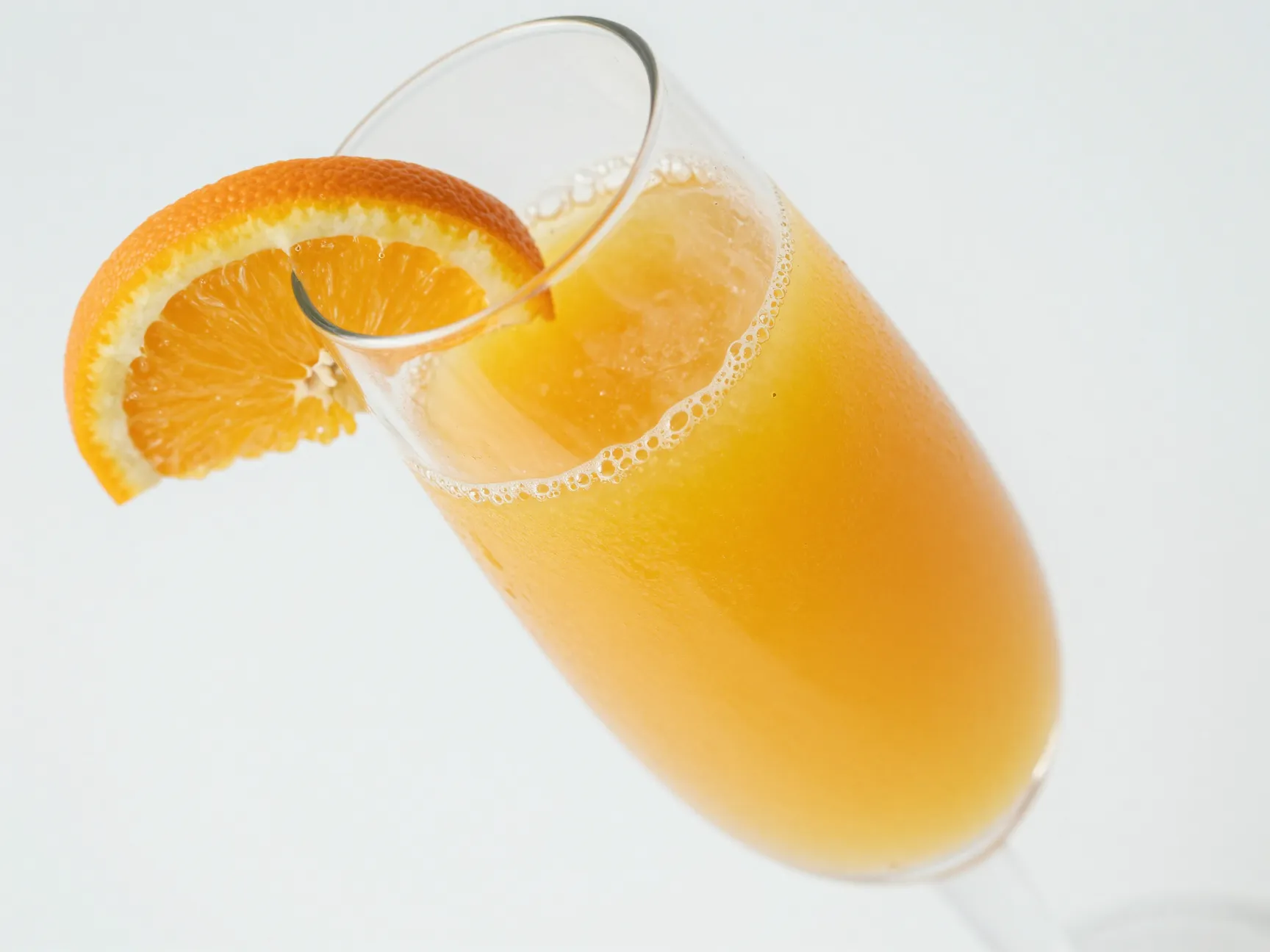 Orange juice and sparkling water in a champagne flute